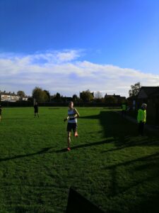 Alex Mitton racing to the finish line of the 10K race